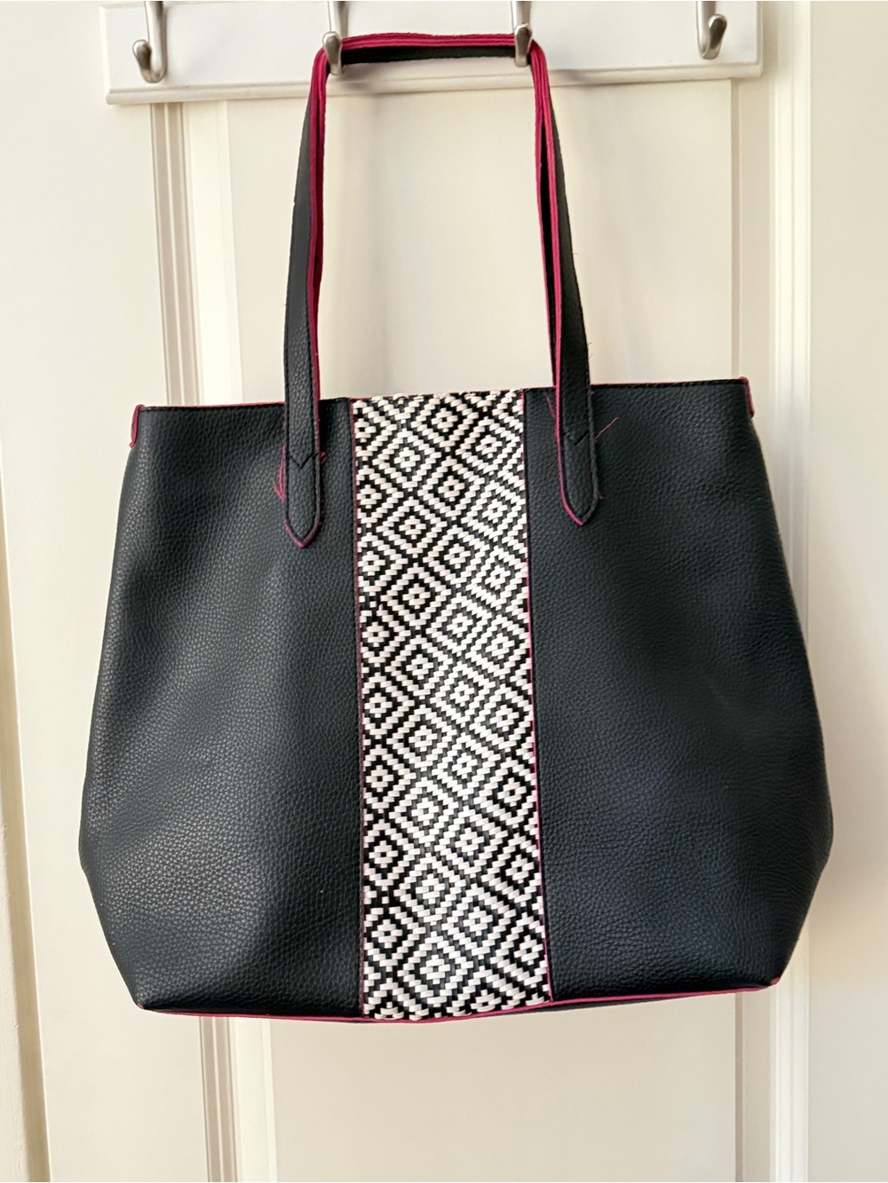 Black and white tote outlined in pink